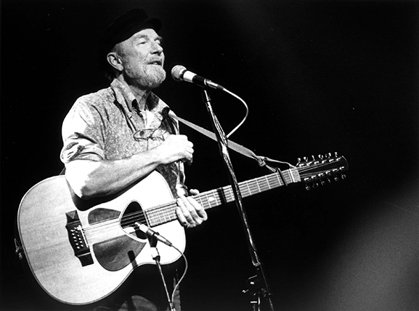 black and white photograph of Pete Seeger singing