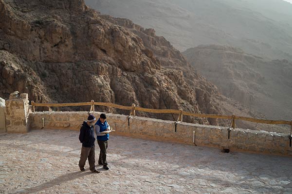 Brother Boutros teaches Mickeal, a young man visiting from Homs for a few days, to read the morning prayer.