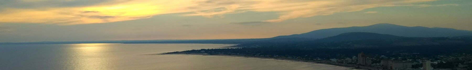 gold and blue sunset over a lakeshore