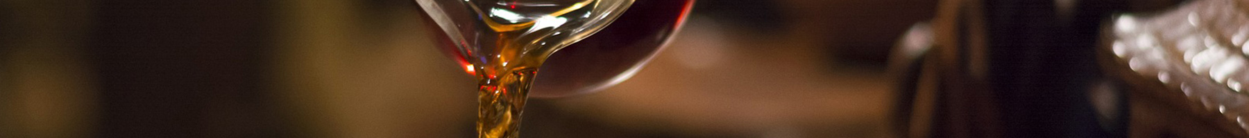 a hand pouring tea in a cup