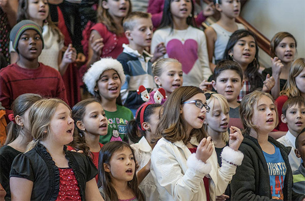 teenagers singing Christmas carols