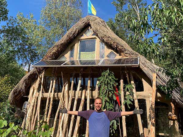 Mark in front of the house he built