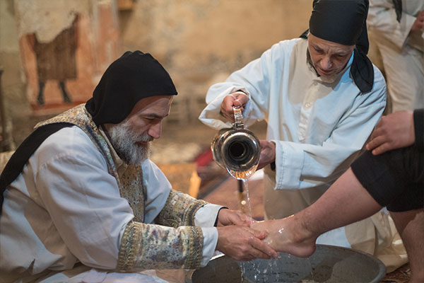 man washing a persons feet