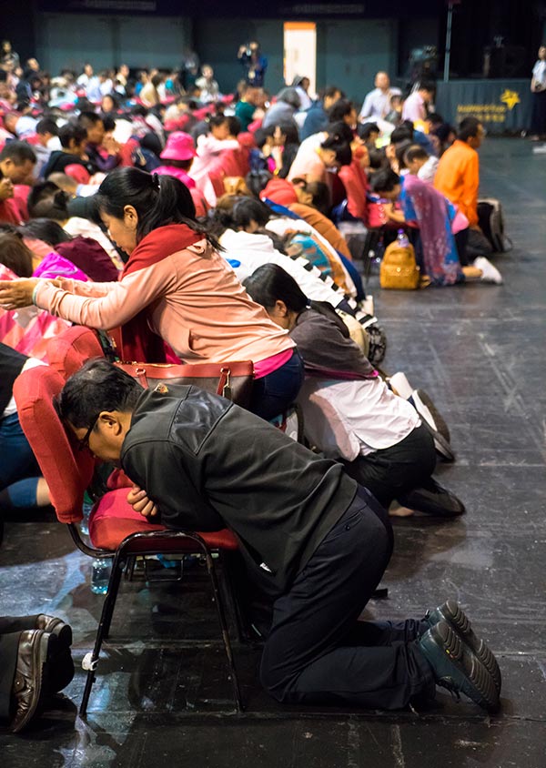 Chinese Christians praying at a conference