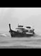 small boat in rough water with rain and clouds