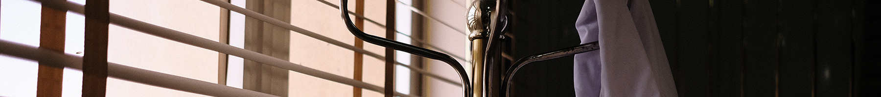 a lab coat hanging by a window