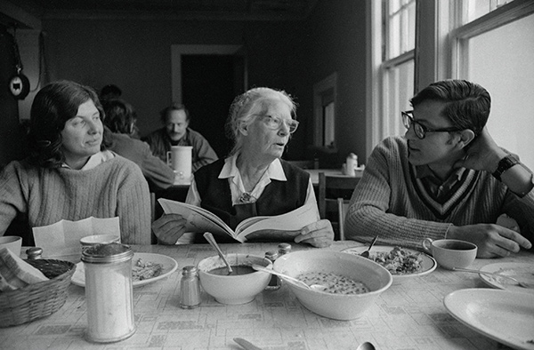 Dorothy Day sharing meal with volunteers