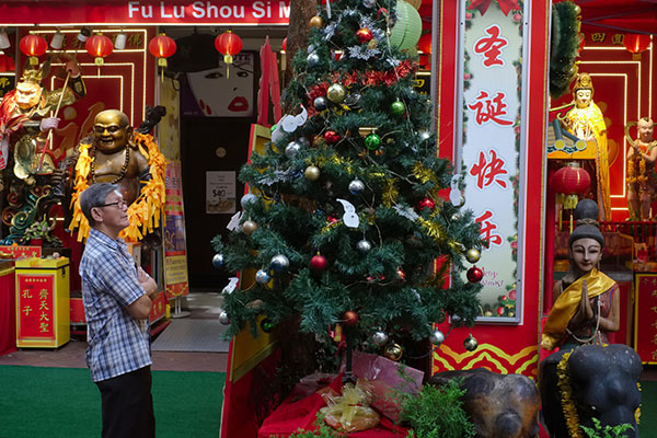 a man looking at a Christmas tree in Singapore