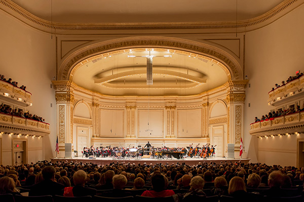 Crowd enjoying orchestra performance in Carnegie Hall