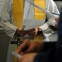 a Navy chaplain conducts prayer on a ship