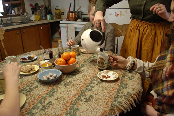 women having tea together at a kitchen table