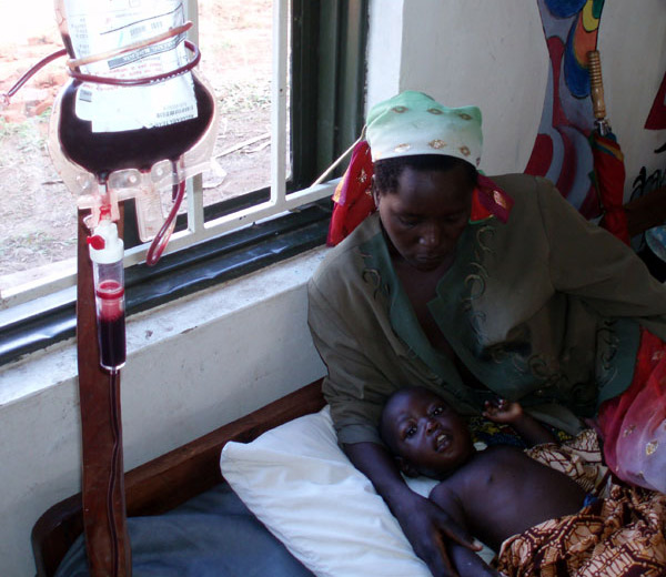 a Ugandan child receiving a transfusion