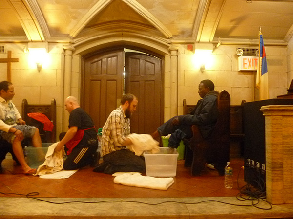 a pastor washing feet at the Bowery Mission