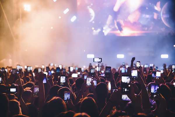 people filming at a concert