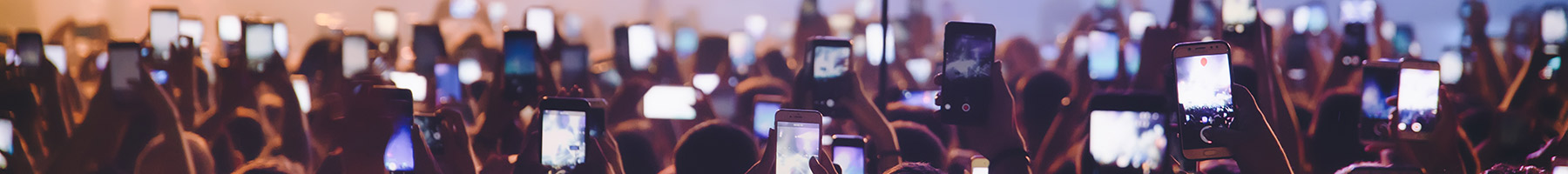 people filming at a concert