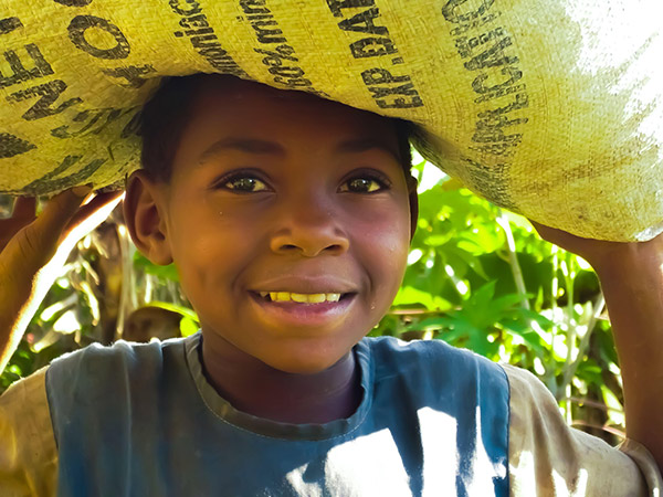 Ugandan boy carries supplies home