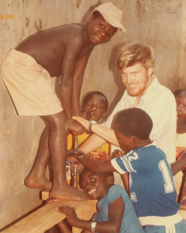 Simeon Wiehler doing an activity with three boys