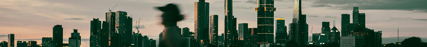 a woman running in front of a city skyline