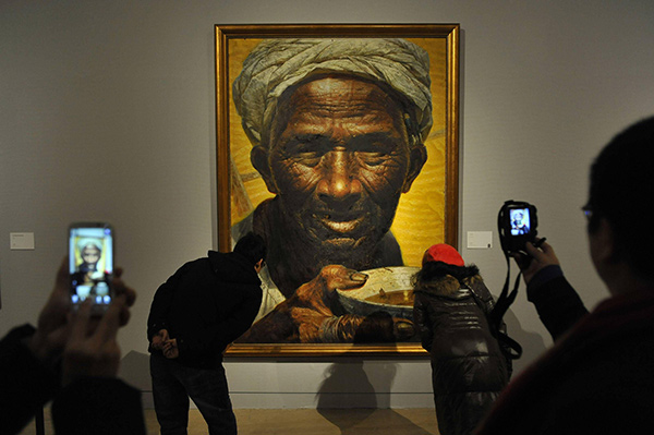 people looking at a painting in a museum