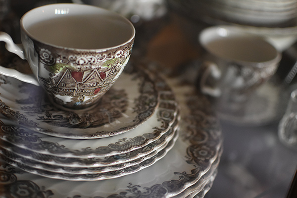 a teacup on a stack of china plates