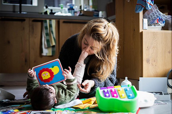 a mom playing with her baby on the floor