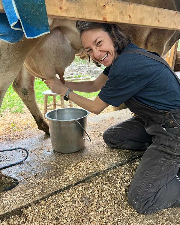 a woman milking a cow