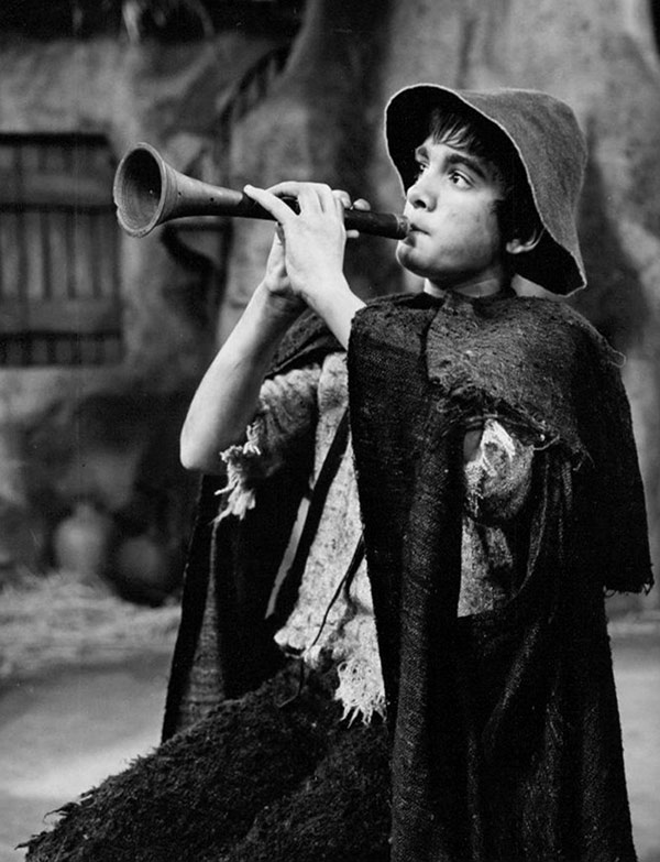 a boy playing a pipe