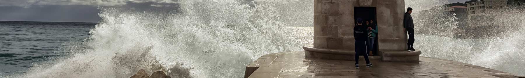 Marseille Lighthouse with dark clouds and waves crashing