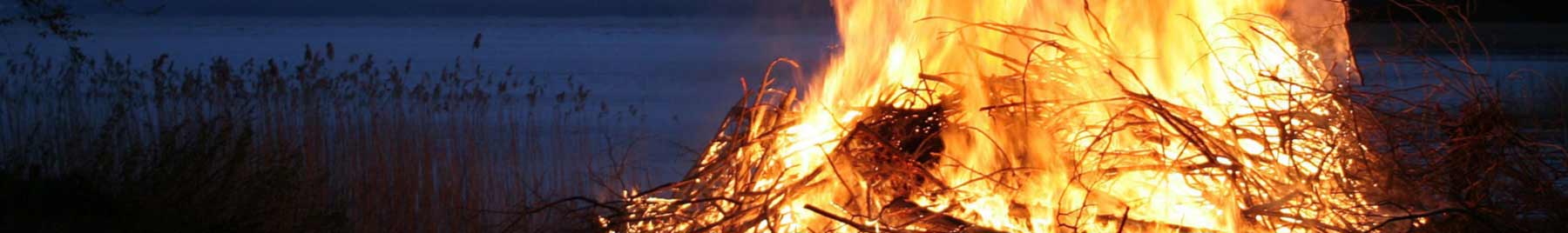 A bonfire in the evening by a lake