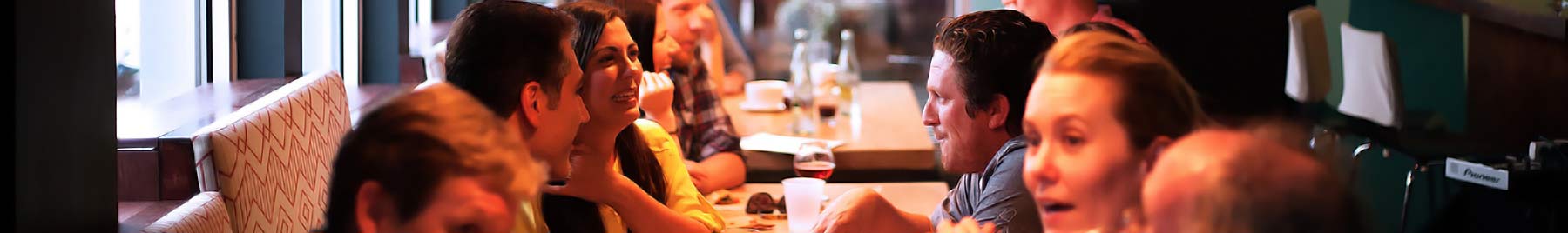 people conversing across a cafe table