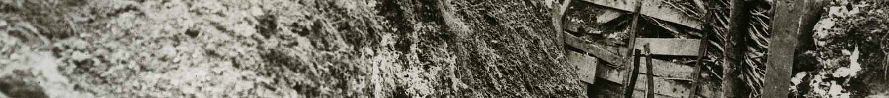 an old photograph of a trench with board sides in World War One