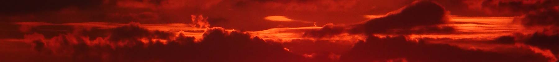 red, maroon, and dark orange clouds at sunset