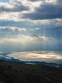 sun shining through clouds on the Sea of Galilee