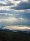 sun shining through clouds on the Sea of Galilee
