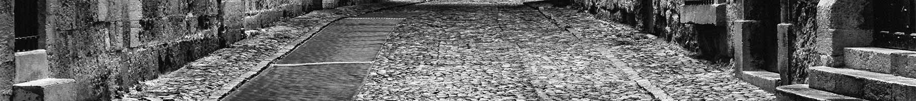 black and white photo of cobbled street