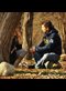 A man and a woman talk under a tree