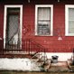 Steps in front of a row house with grafitti in the city