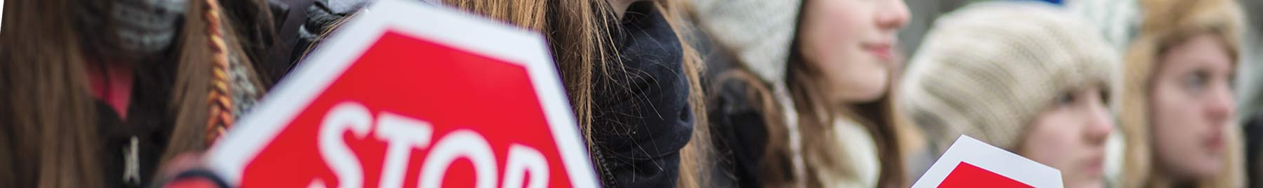 A line of women holding signs at a pro-life rally