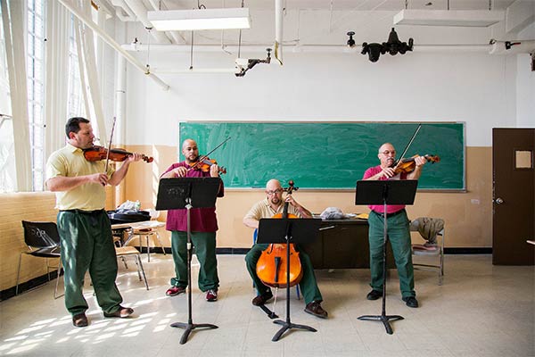 four men playing string instruments