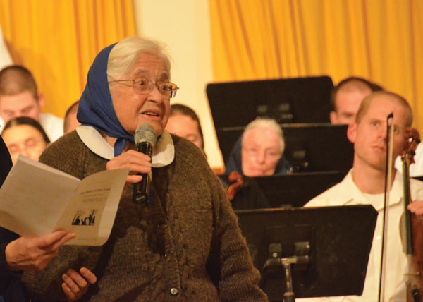 Marlys Swinger introducing one of her choral works, 2014