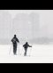 a man and a boy skiing in the snow