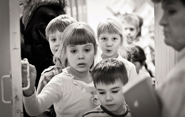 a line of children entering a door