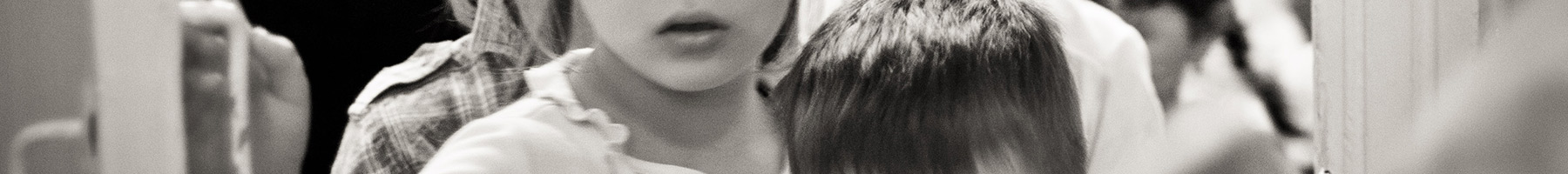 a line of children entering a door