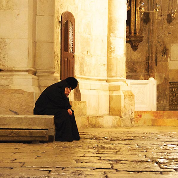 A pilgrim rests at the Church of the Holy Sepulchre, Jerusalem.