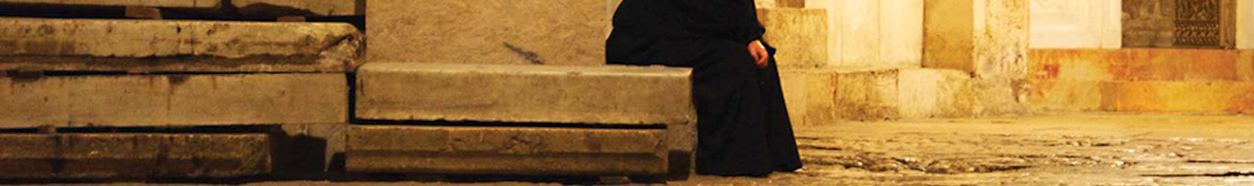 A pilgrim rests at the Church of the Holy Sepulchre, Jerusalem.