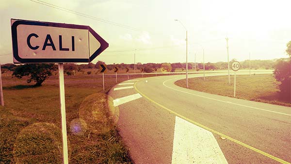 a road sign pointing to Cali