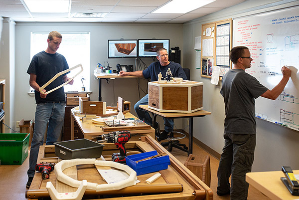 men designing play equipment for children