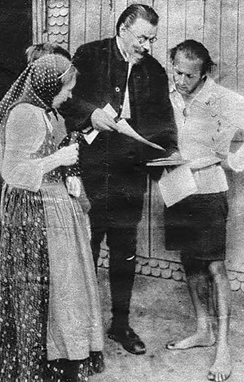 Eberhard Arnold and colleagues looking over a manuscript for typesetting