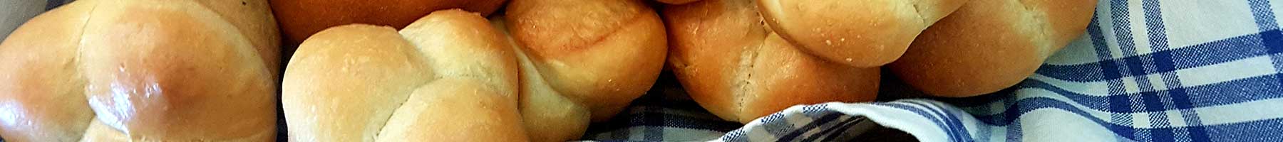 different types of bread on a blue checked cloth