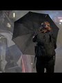 a woman holding a black umbrella